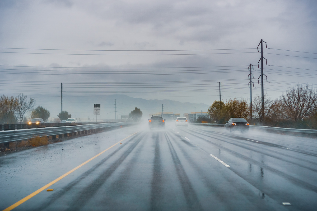 cars driving on the highway in the rain